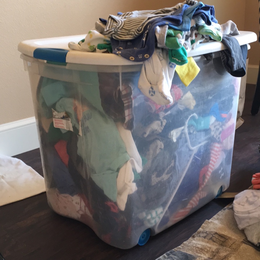 Box of baby boy clothes.